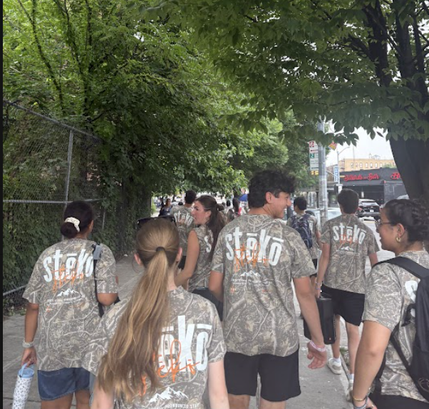 Joshua Generation participants walking together along a tree-lined sidewalk