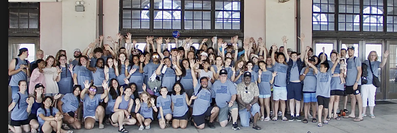 Joshua Generation group together in blue shirts at the oceanfront pavilion