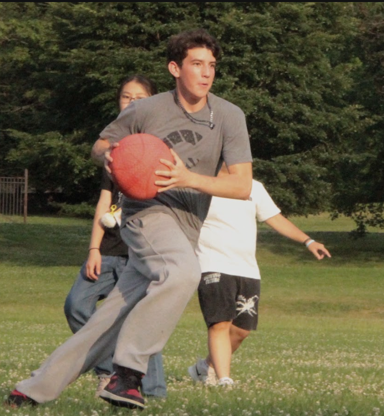 A participant running with a ball during an outdoor game